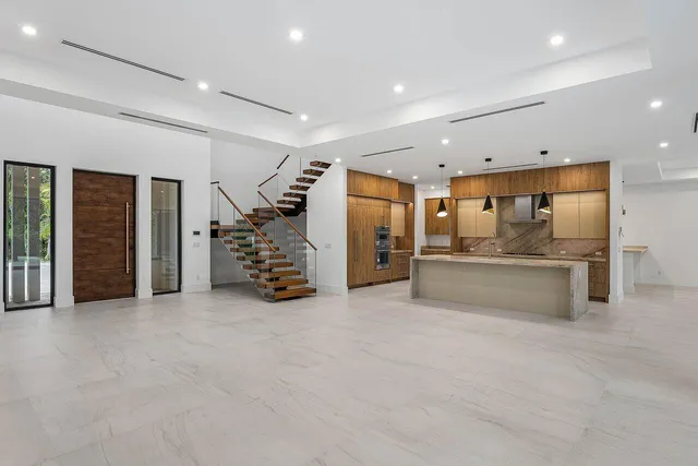 a view of an empty room with wooden floor and a floor to ceiling window