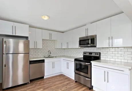 a kitchen with stainless steel appliances a refrigerator stove microwave and sink