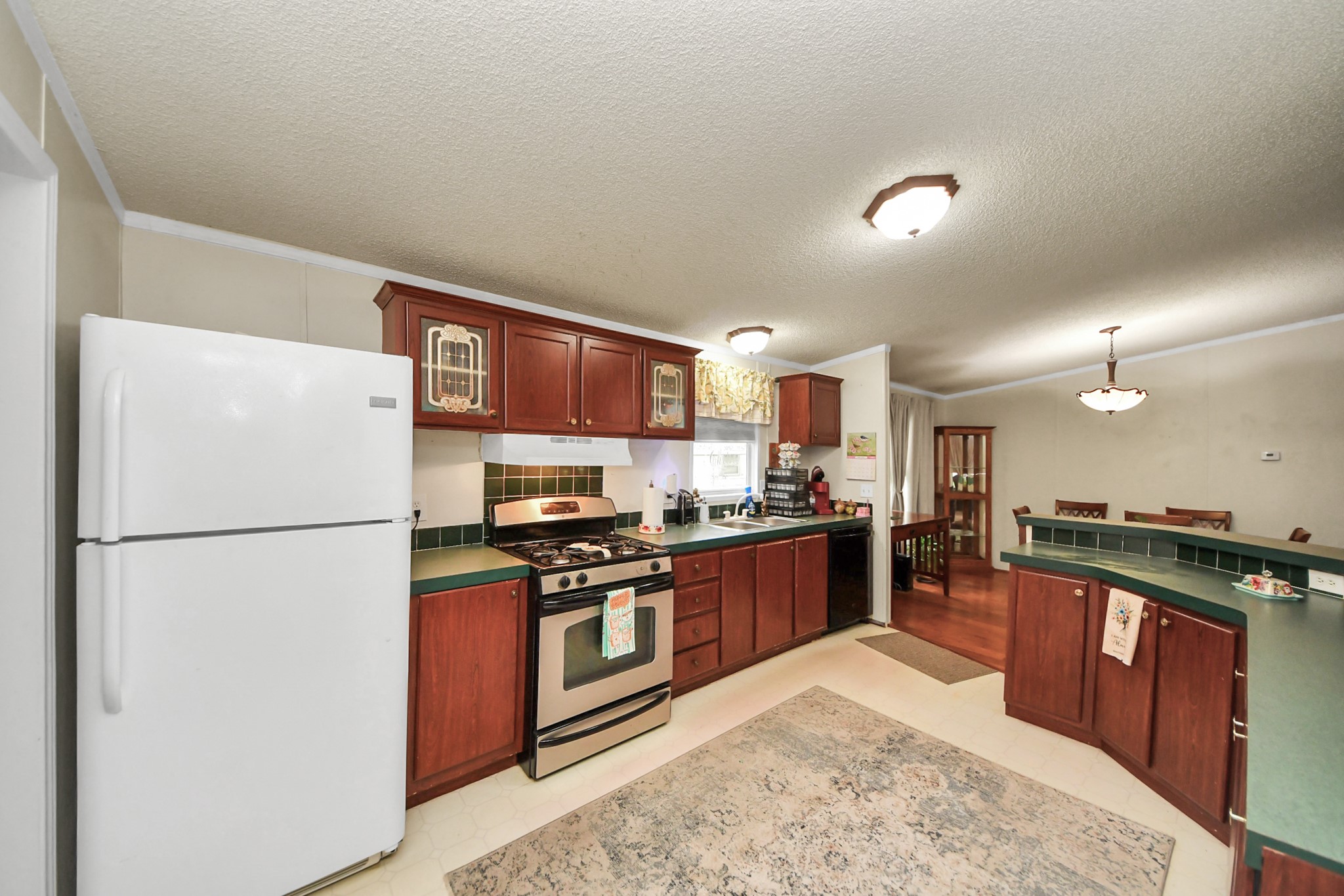 204 Edith Street Highlands, TX 77562 - Photo 22 of 33 a kitchen with stainless steel appliances granite countertop a stove a refrigerator and a sink