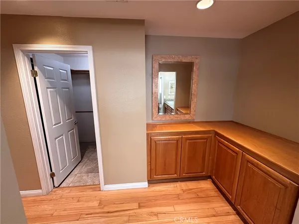 a view of a hallway view with wooden floor and staircase