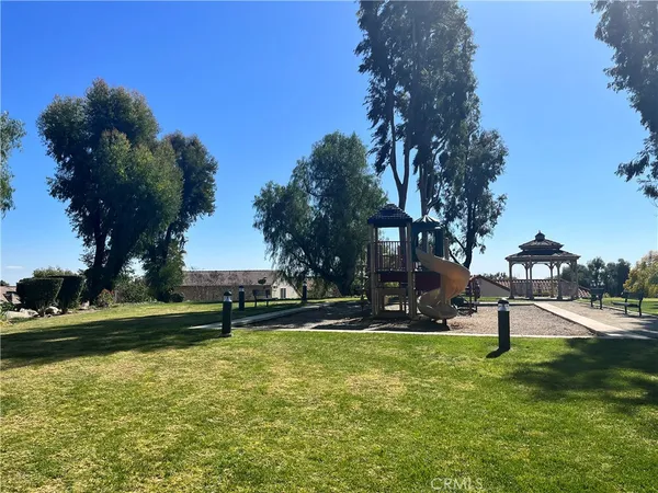 a view of a park with swings and slides
