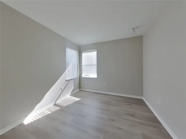 a view of a big room with closet and windows