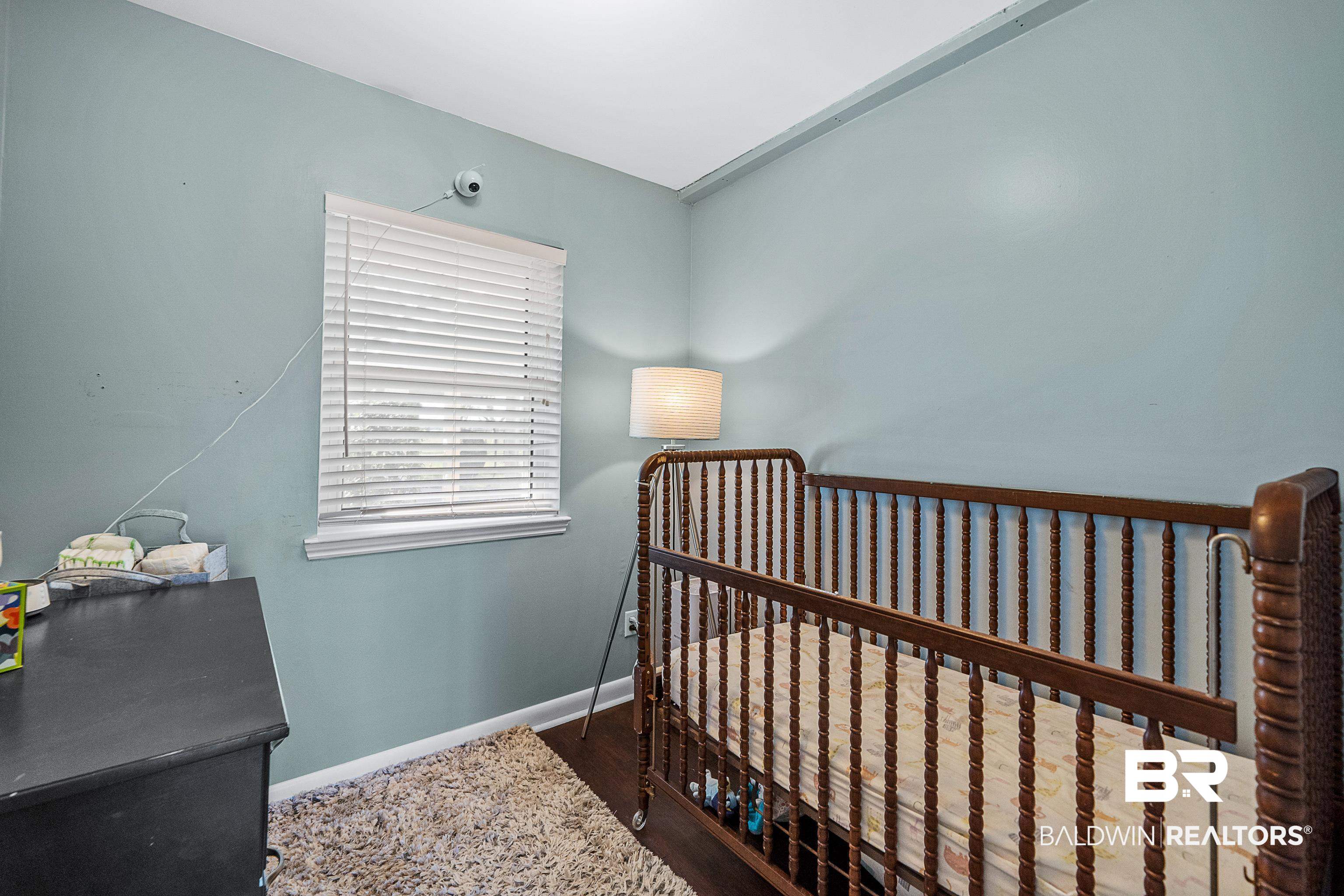 10196 Stucki Road Elberta, AL 36530 - Photo 24 of 54 Bedroom with dark wood-style floors and a nursery area