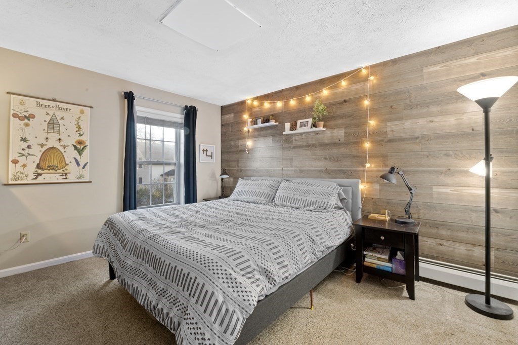 9 Sudbury Street, Unit 9 Maynard, MA 01754 - Photo 15 of 35 a bedroom with a bed and a table