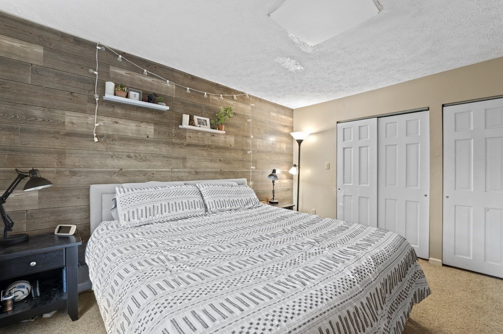 9 Sudbury Street, Unit 9 Maynard, MA 01754 - Photo 17 of 35 a bedroom with a large bed and a table