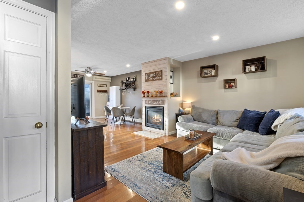 9 Sudbury Street, Unit 9 Maynard, MA 01754 - Photo 2 of 35 a living room with furniture and a fireplace