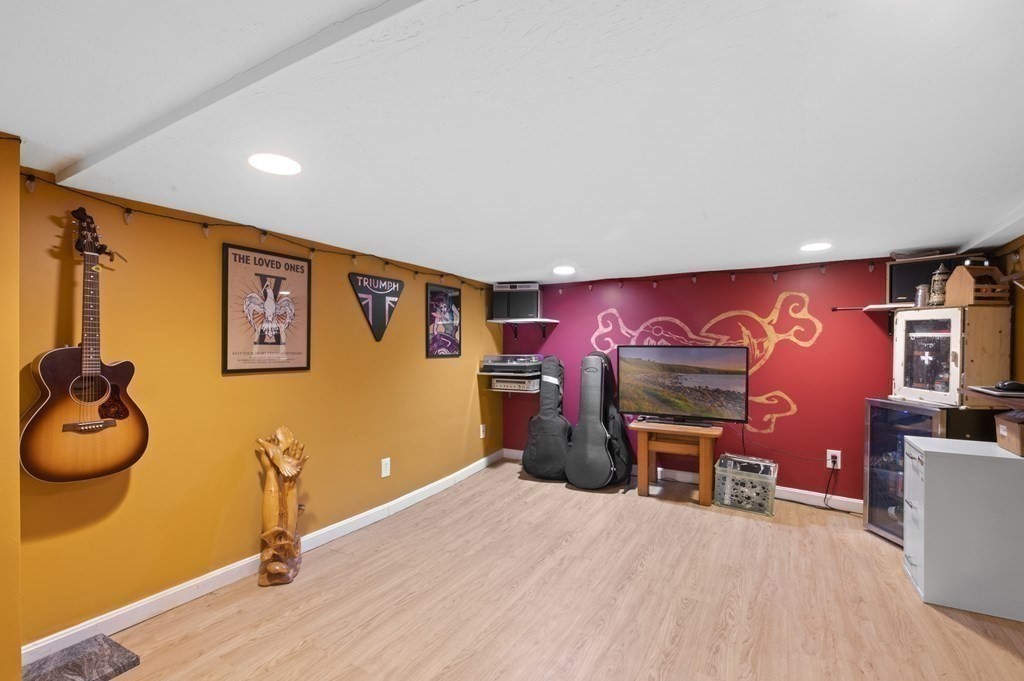 9 Sudbury Street, Unit 9 Maynard, MA 01754 - Photo 23 of 35 a room with furniture and a flat screen tv