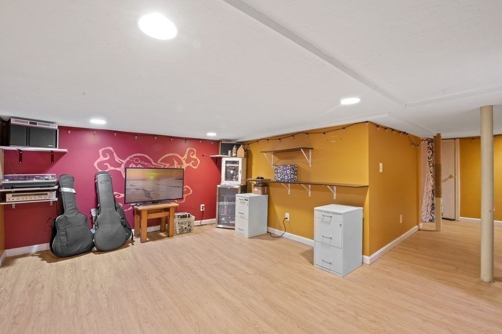 9 Sudbury Street, Unit 9 Maynard, MA 01754 - Photo 24 of 35 a bedroom with furniture and a flat screen tv