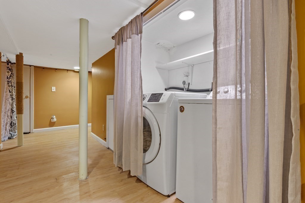 9 Sudbury Street, Unit 9 Maynard, MA 01754 - Photo 25 of 35 a view of washer and dryer with bathroom in the background