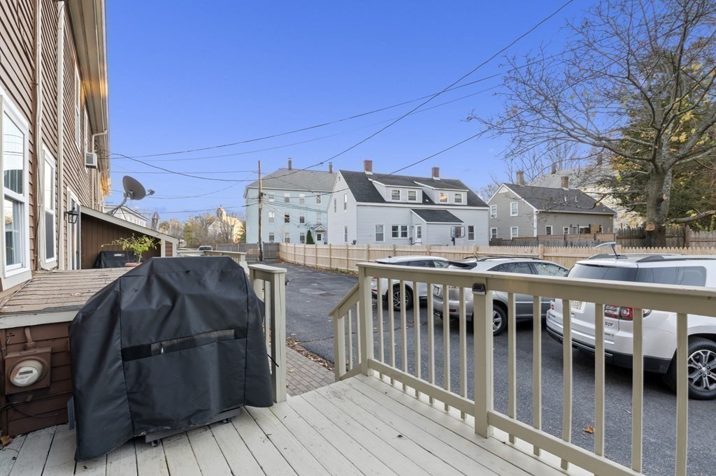9 Sudbury Street, Unit 9 Maynard, MA 01754 - Photo 30 of 35 a view of a roof deck with wooden fence and a couple of chairs