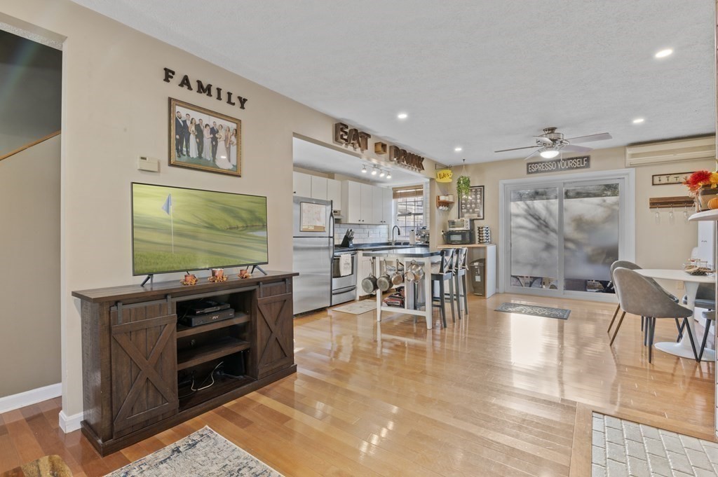 9 Sudbury Street, Unit 9 Maynard, MA 01754 - Photo 3 of 35 a dining room with furniture and a flat screen tv