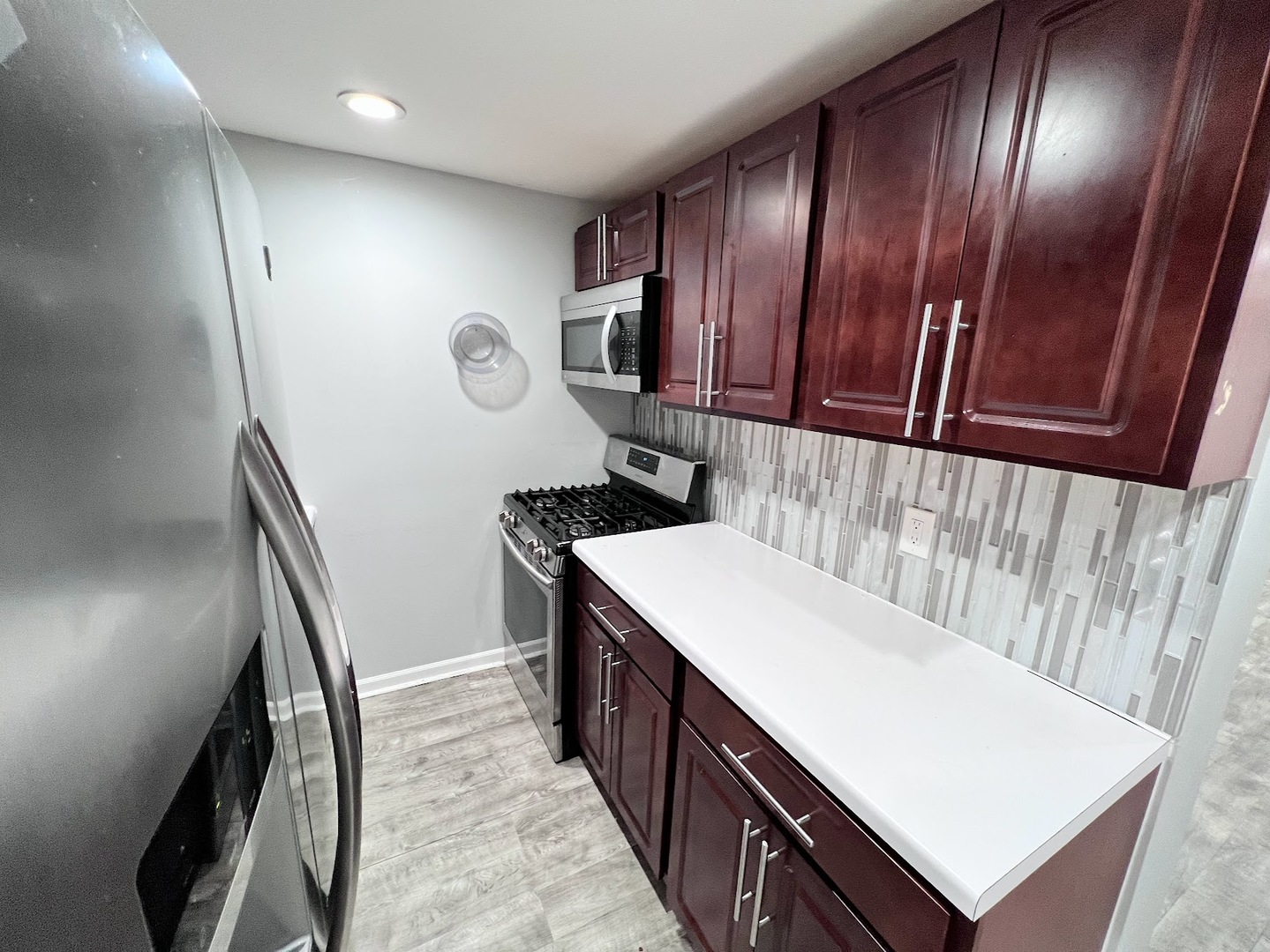 3335 North Kenneth Avenue, Unit G Chicago, IL 60641 - Photo 5 of 13 a hallway with washer dryer and wooden cabinets