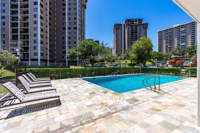 a view of yard with swimming pool and green space