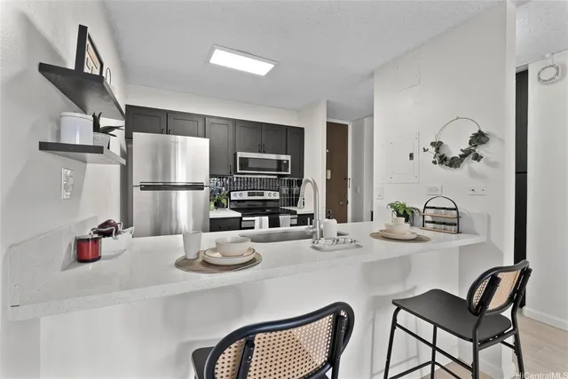 a kitchen with a refrigerator and dining table