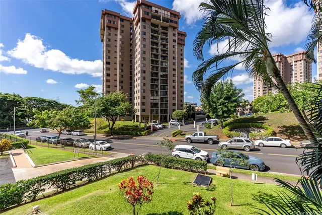 a view of a swimming pool with lawn chairs under an umbrella