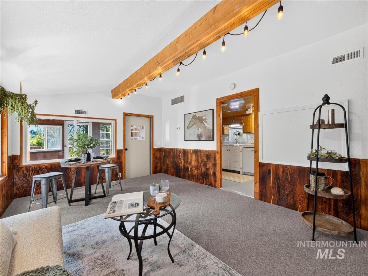 6 Rattlesnake Road Boise City, ID 83716 - Photo 19 of 50 Spacious room with a vaulted ceiling, exposed wood beam with string lighting, and wood paneling