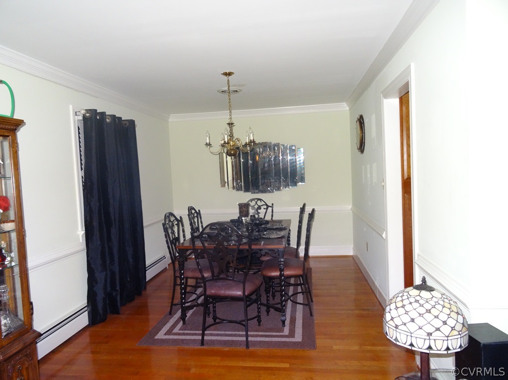 15615 Loving Union Road Disputanta, VA 23842 - Photo 8 of 24 a view of a dining room with furniture and wooden floor