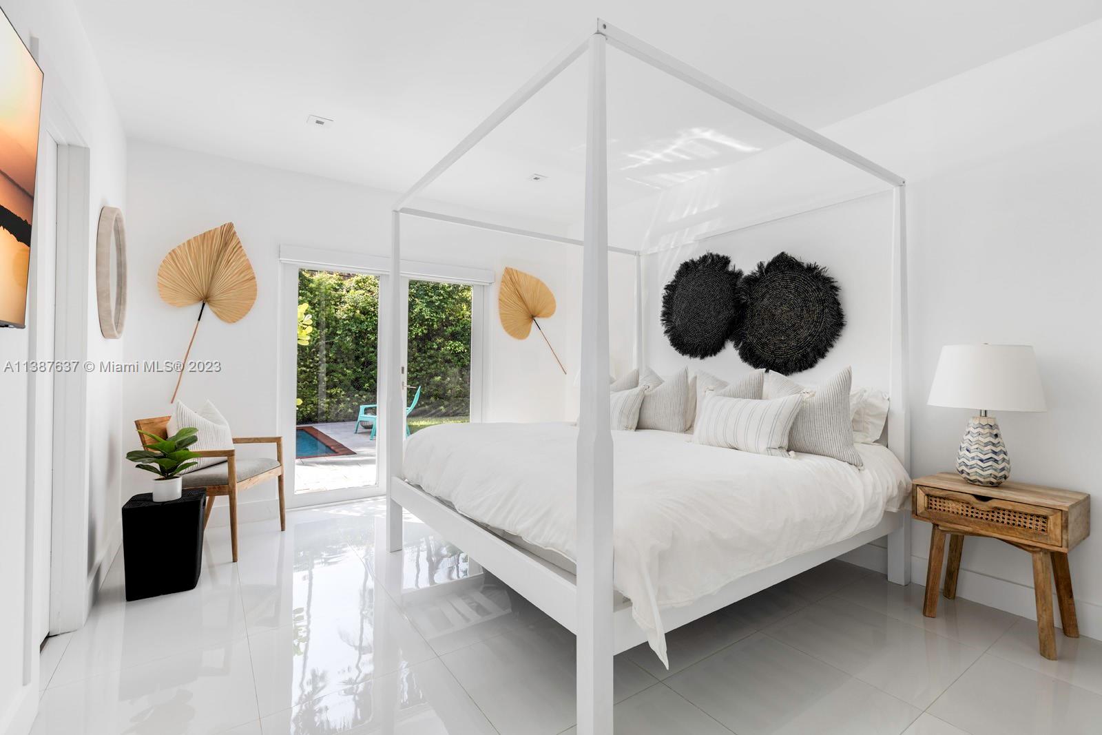 3020 Alton Road Miami Beach, FL 33140 - Photo 17 of 29 a bedroom with a bed and a large window