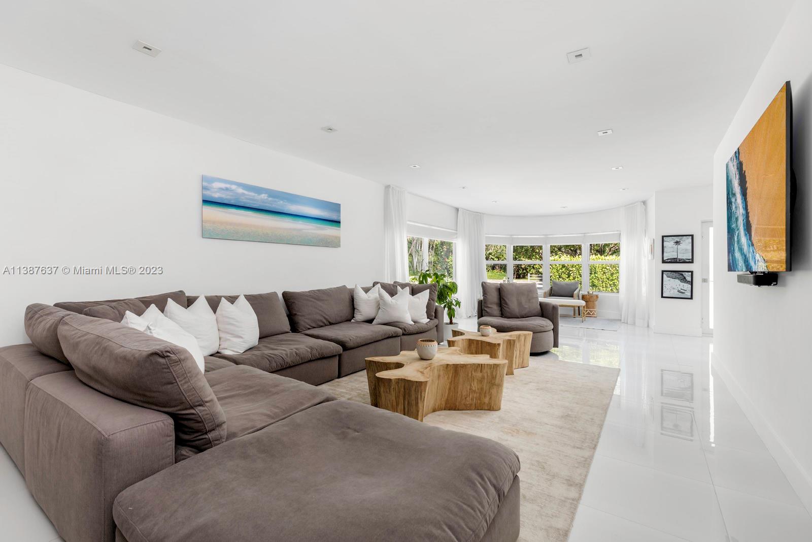 3020 Alton Road Miami Beach, FL 33140 - Photo 8 of 29 a living room with fireplace furniture and a flat screen tv