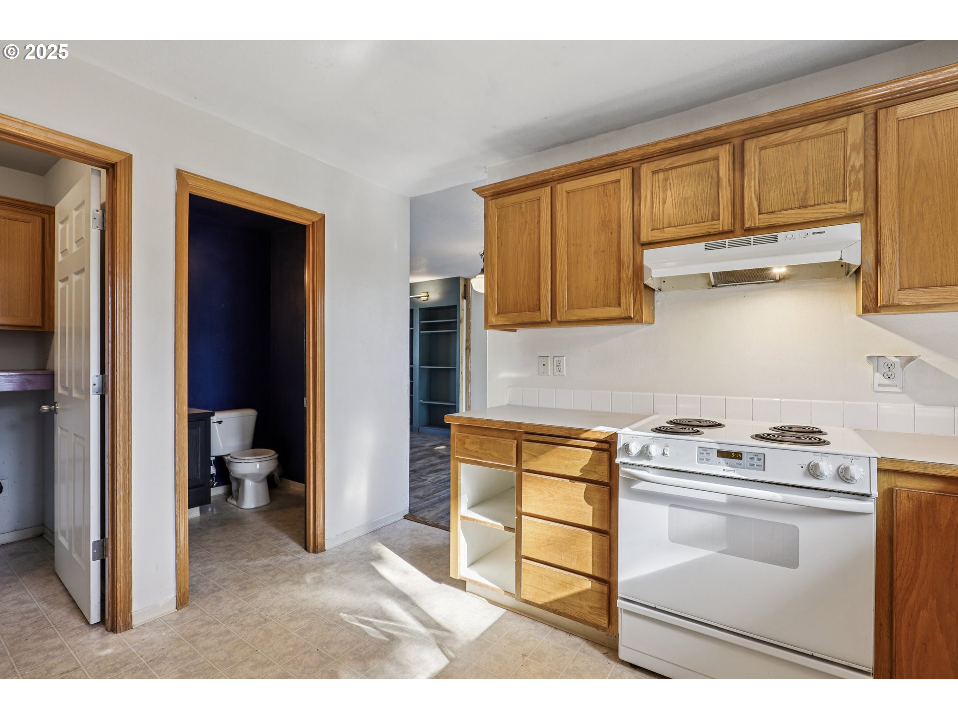 52866 Northeast 2nd Street Scappoose, OR 97056 - Photo 12 of 33 a kitchen with a stove and a cabinet