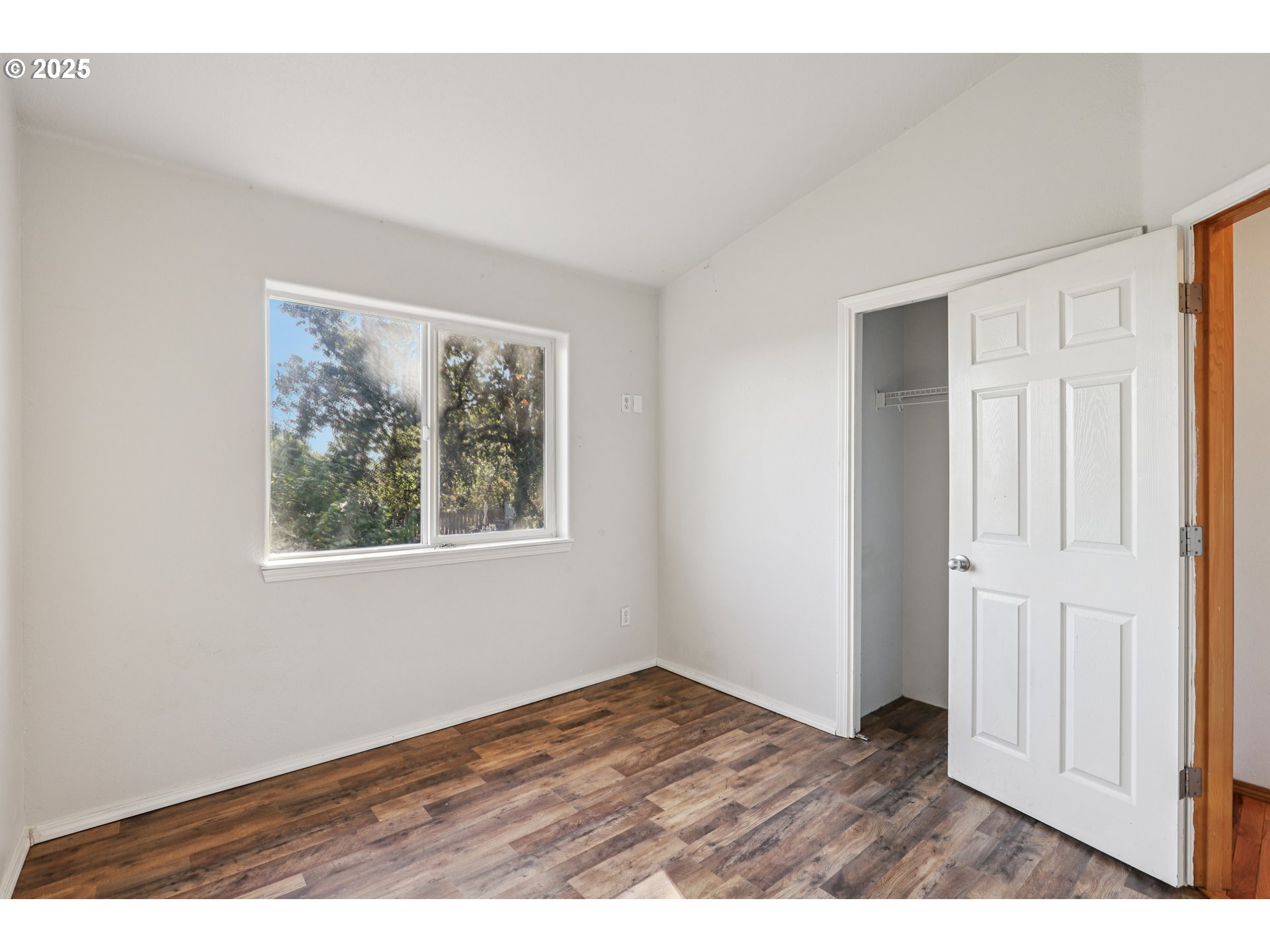 52866 Northeast 2nd Street Scappoose, OR 97056 - Photo 23 of 33 a view of an empty room with window and wooden floor