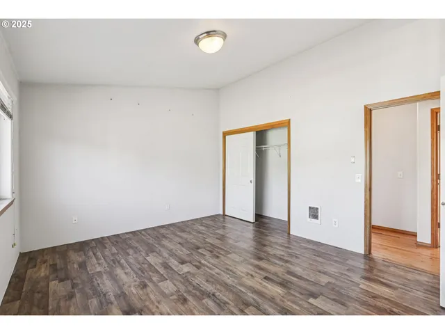 a view of an empty room and wooden floor