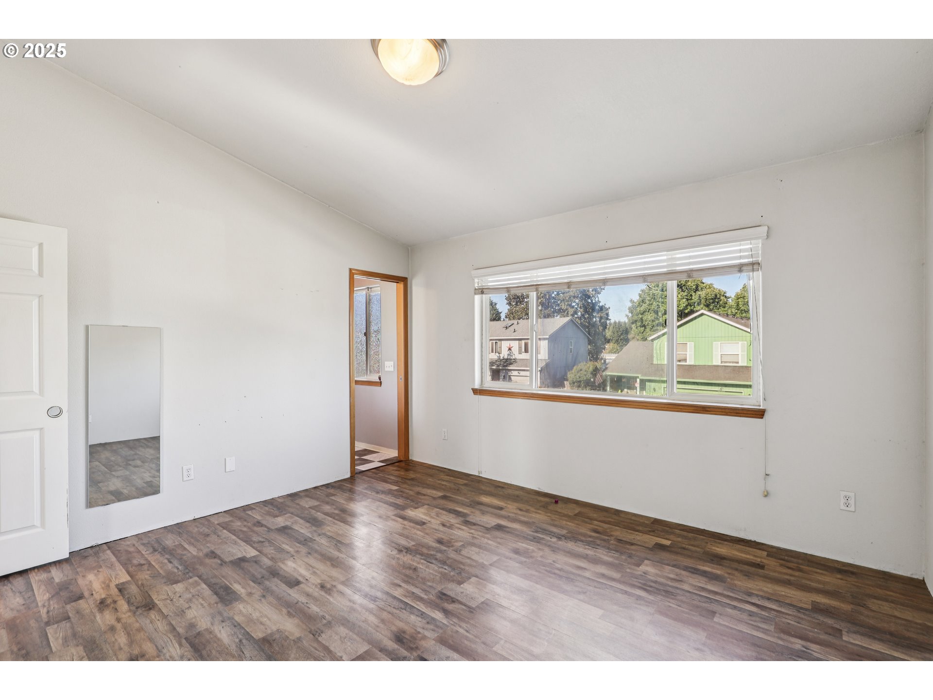 52866 Northeast 2nd Street Scappoose, OR 97056 - Photo 27 of 33 a view of an empty room with wooden floor and a window