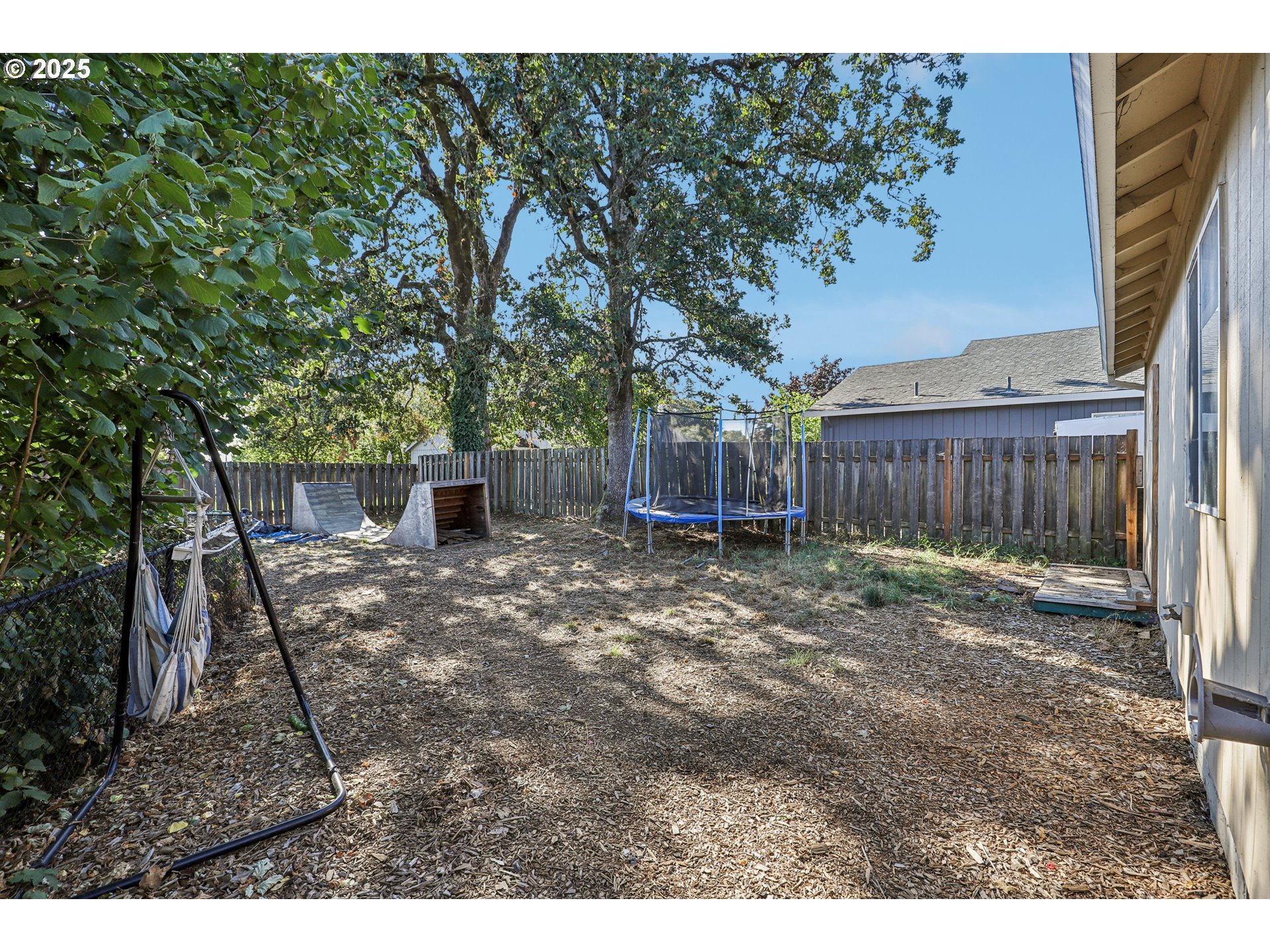 52866 Northeast 2nd Street Scappoose, OR 97056 - Photo 29 of 33 a view of a backyard with large trees and wooden fence