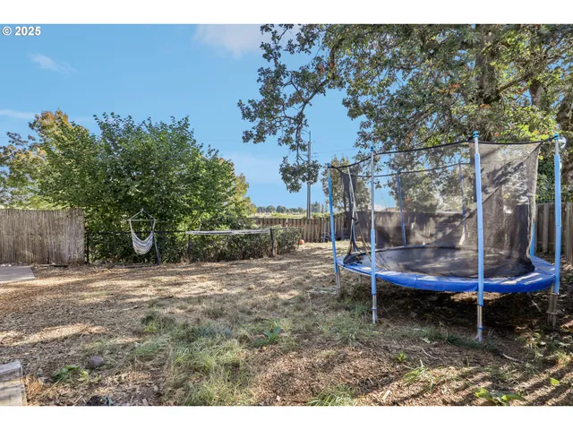 a backyard of a house with barbeque oven table and chairs