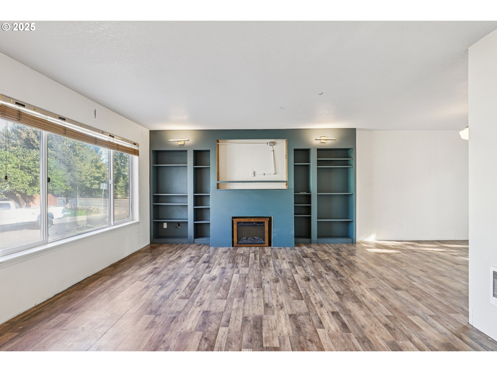 52866 Northeast 2nd Street Scappoose, OR 97056 - Photo 3 of 33 a view of an empty room with a window and kitchen view