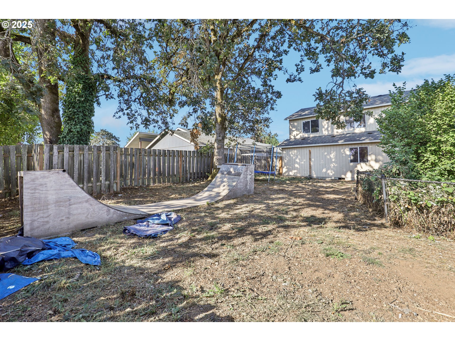 52866 Northeast 2nd Street Scappoose, OR 97056 - Photo 31 of 33 a view of a deck with chair and wooden fence