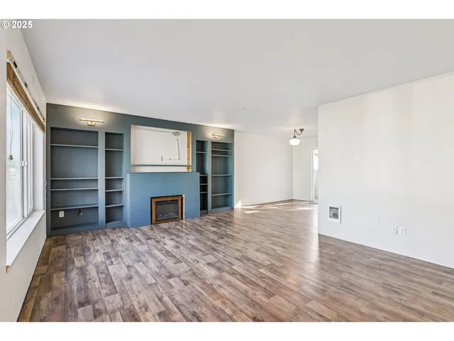 a view of empty room with a fireplace and cabinet