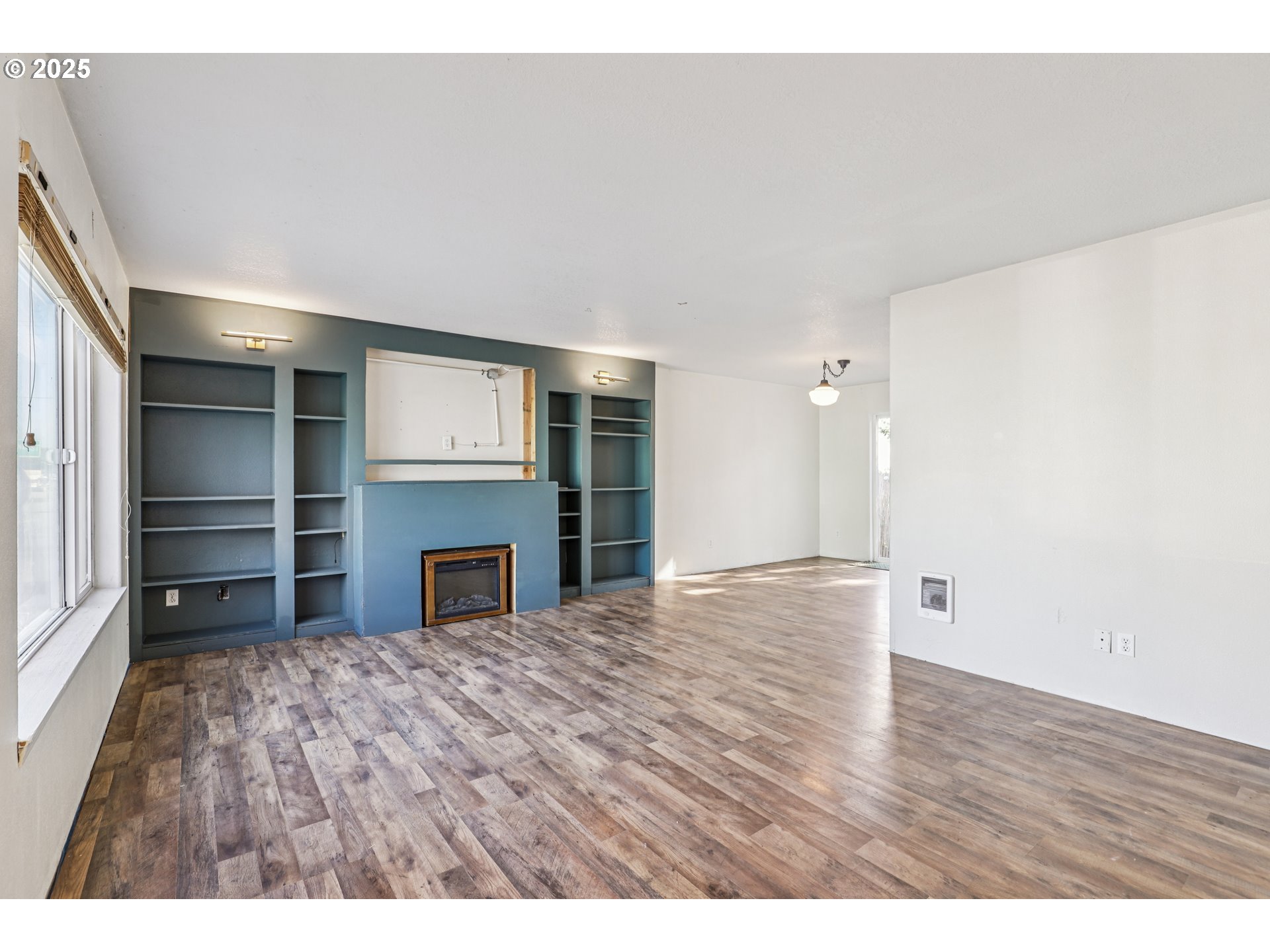 52866 Northeast 2nd Street Scappoose, OR 97056 - Photo 4 of 33 a view of empty room with a fireplace and cabinet