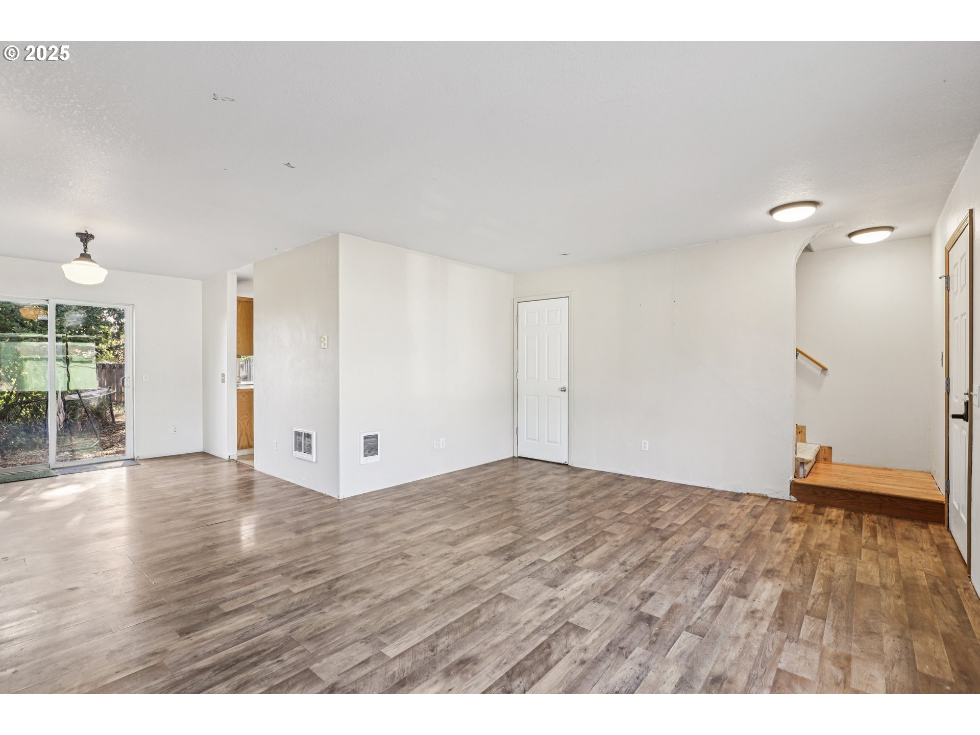 52866 Northeast 2nd Street Scappoose, OR 97056 - Photo 6 of 33 a view of an empty room with wooden floor