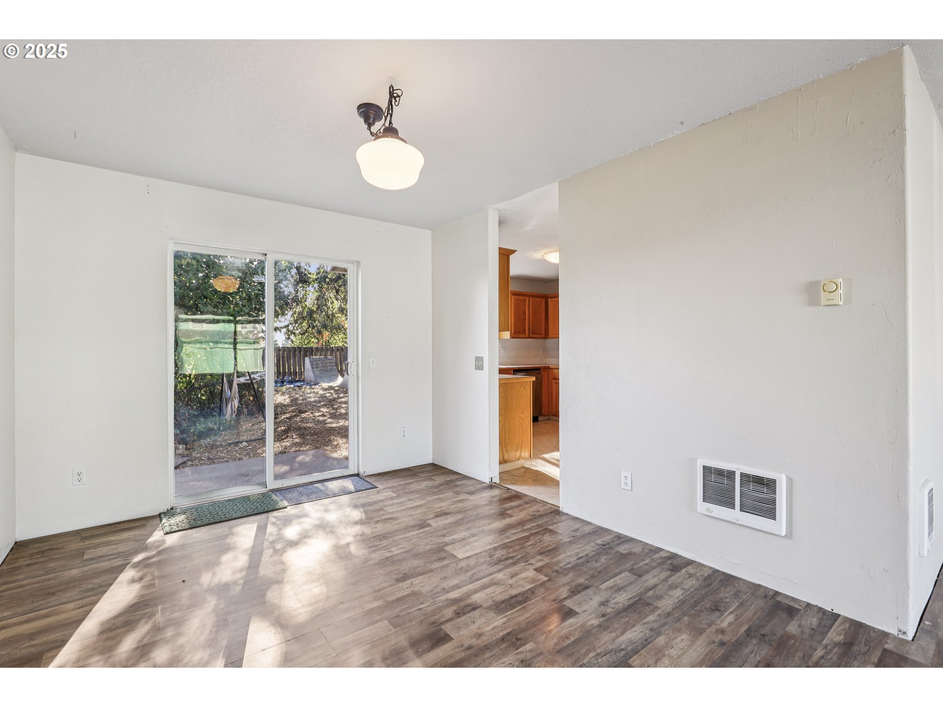 52866 Northeast 2nd Street Scappoose, OR 97056 - Photo 7 of 33 a view of an empty room with wooden floor and a window