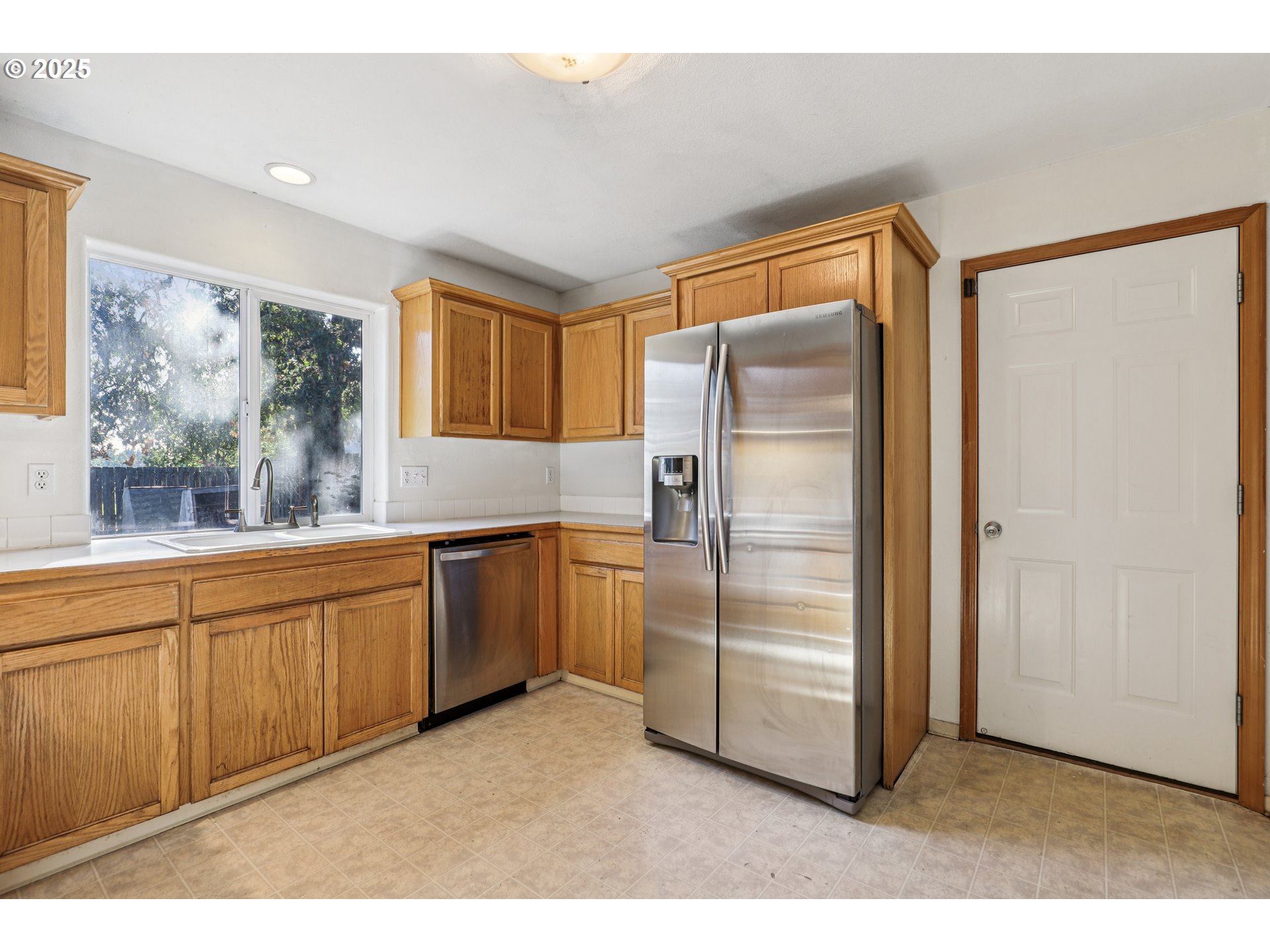52866 Northeast 2nd Street Scappoose, OR 97056 - Photo 10 of 33 a kitchen with stainless steel appliances granite countertop a refrigerator and a sink