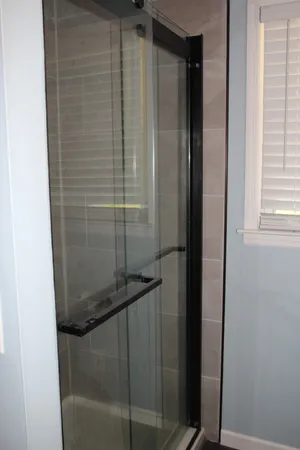 a bathroom with a glass shower door