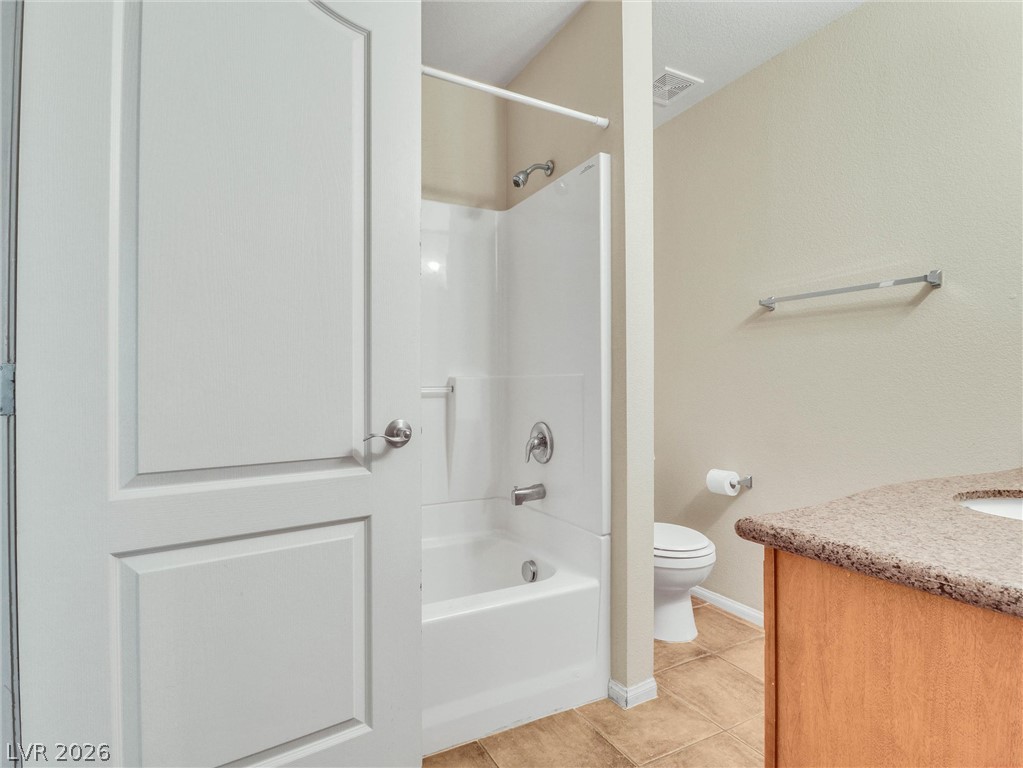 3145 East Flamingo Road, Unit 2129 Las Vegas, NV 89121 - Photo 26 of 43 Functional bathroom features a clean tub-shower combination, a simple vanity, and ceramic tile flooring.