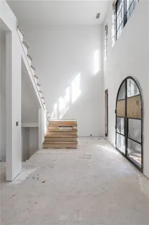 a view of a livingroom with furniture and staircase