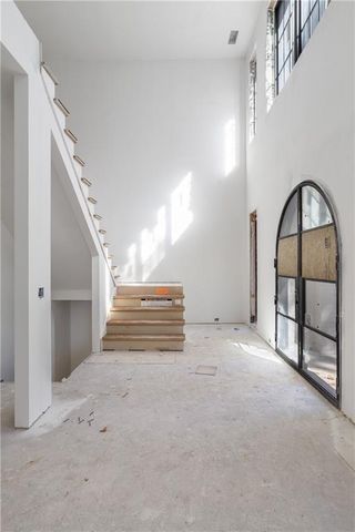 a view of a livingroom with furniture and staircase