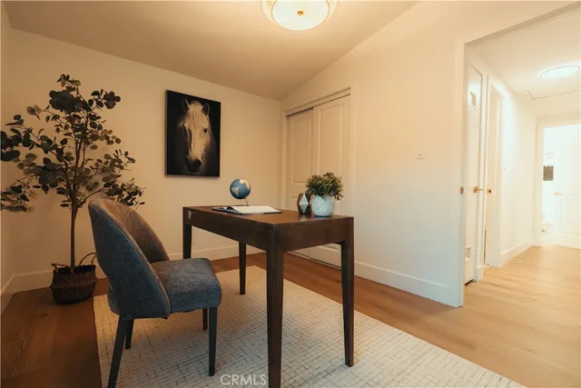 a work room with furniture and a potted plant