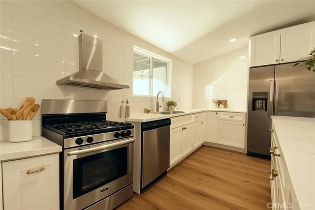 a kitchen with a stove a sink and a refrigerator