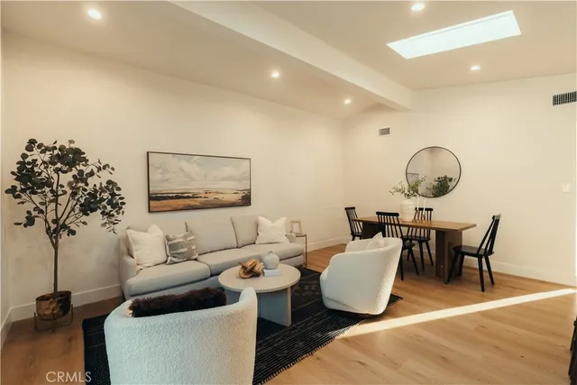 a living room with furniture and a mirror