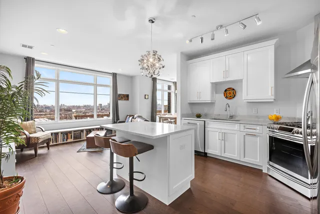 a large white kitchen with a large window