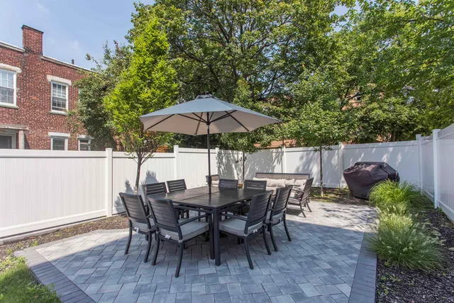 a view of table and chairs under an umbrella