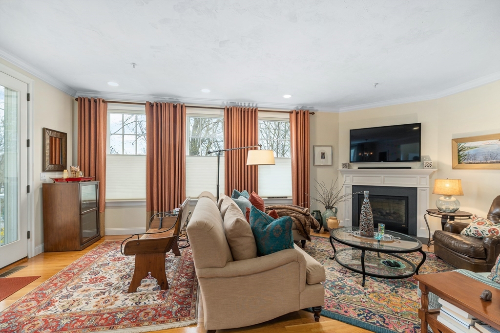 6 Essex Road, Unit 8 Ipswich, MA 01938 - Photo 8 of 35 a living room with furniture flat screen tv and a fireplace