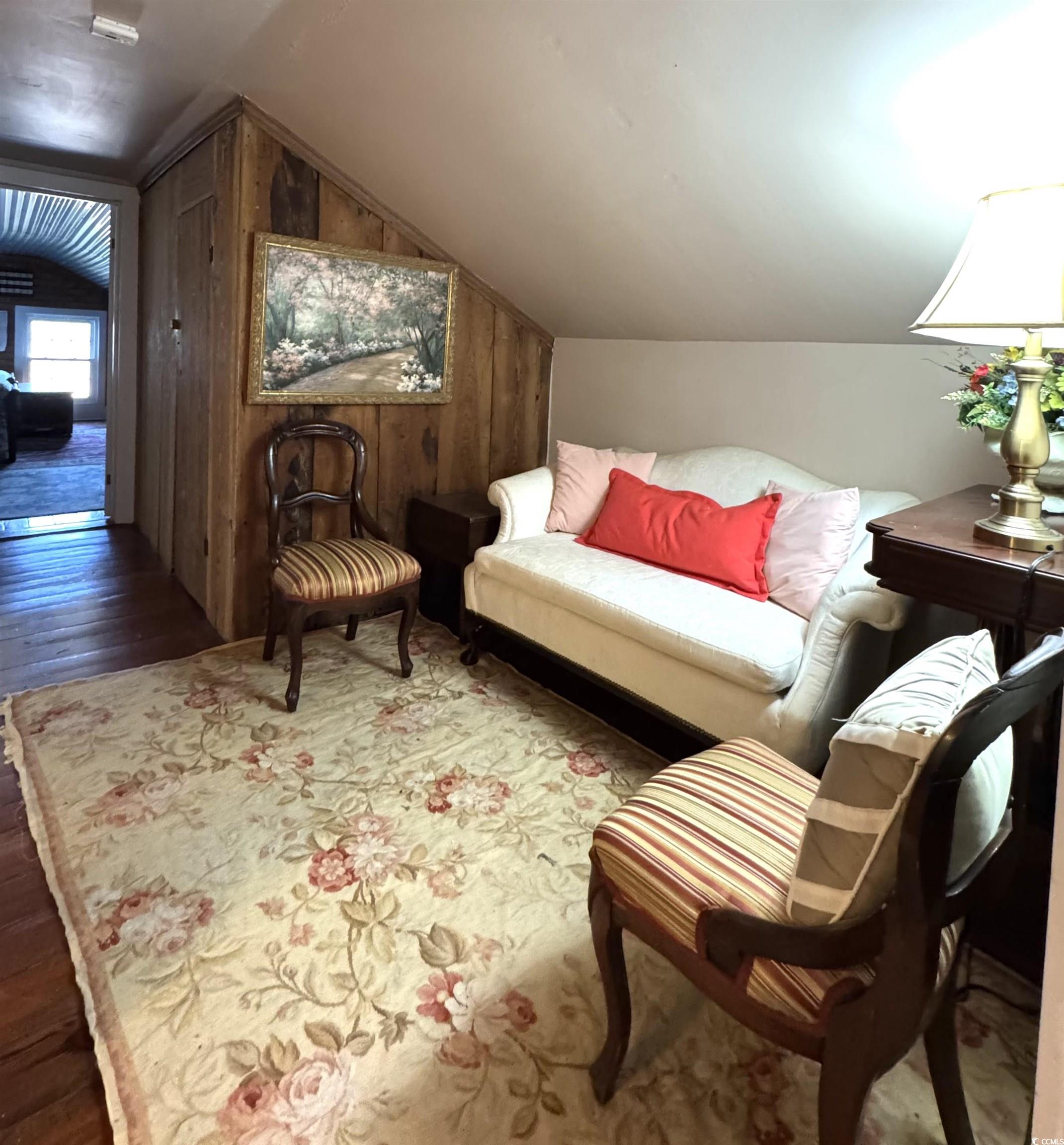 10463 County Line Road Hemingway, SC 29554 - Photo 17 of 40 Living area featuring lofted ceiling, hardwood / wood-style flooring, and wooden walls