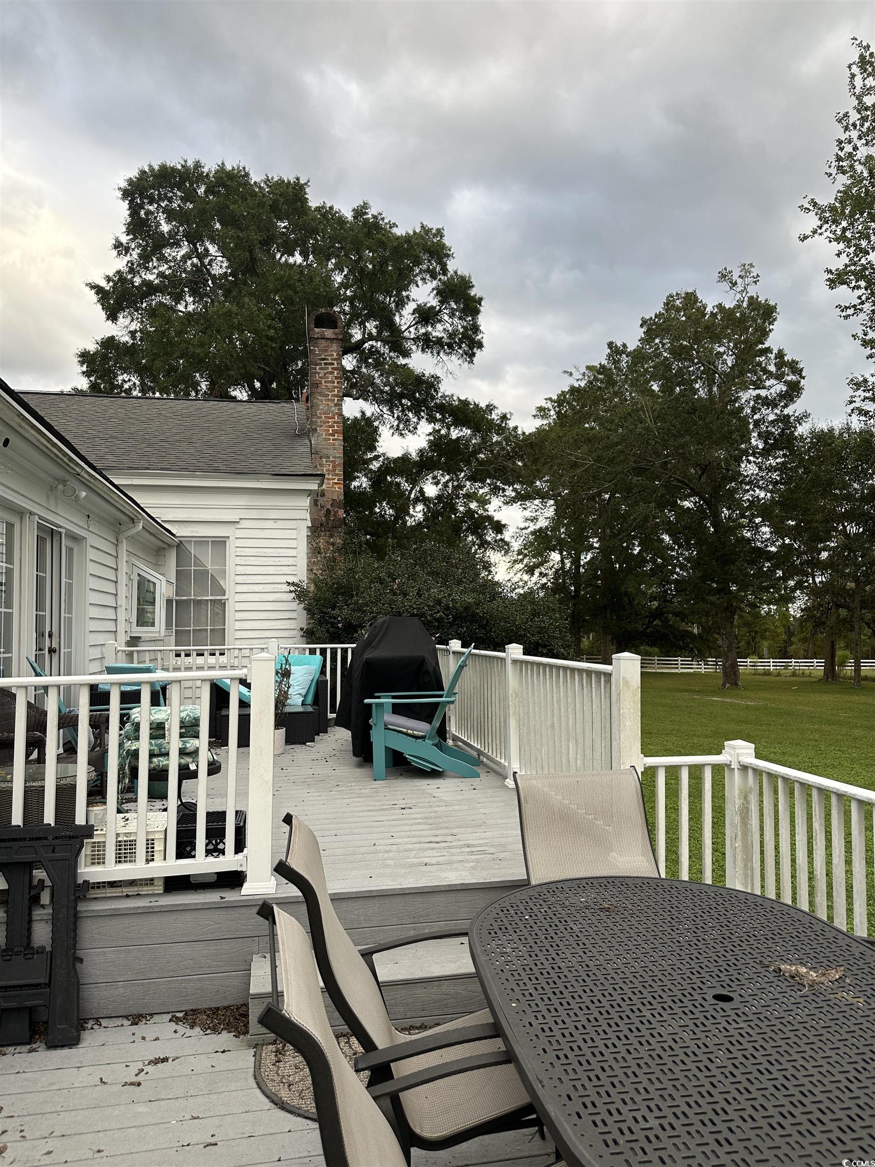 10463 County Line Road Hemingway, SC 29554 - Photo 29 of 40 View of patio / terrace with outdoor dining space, a wooden deck, and area for grilling