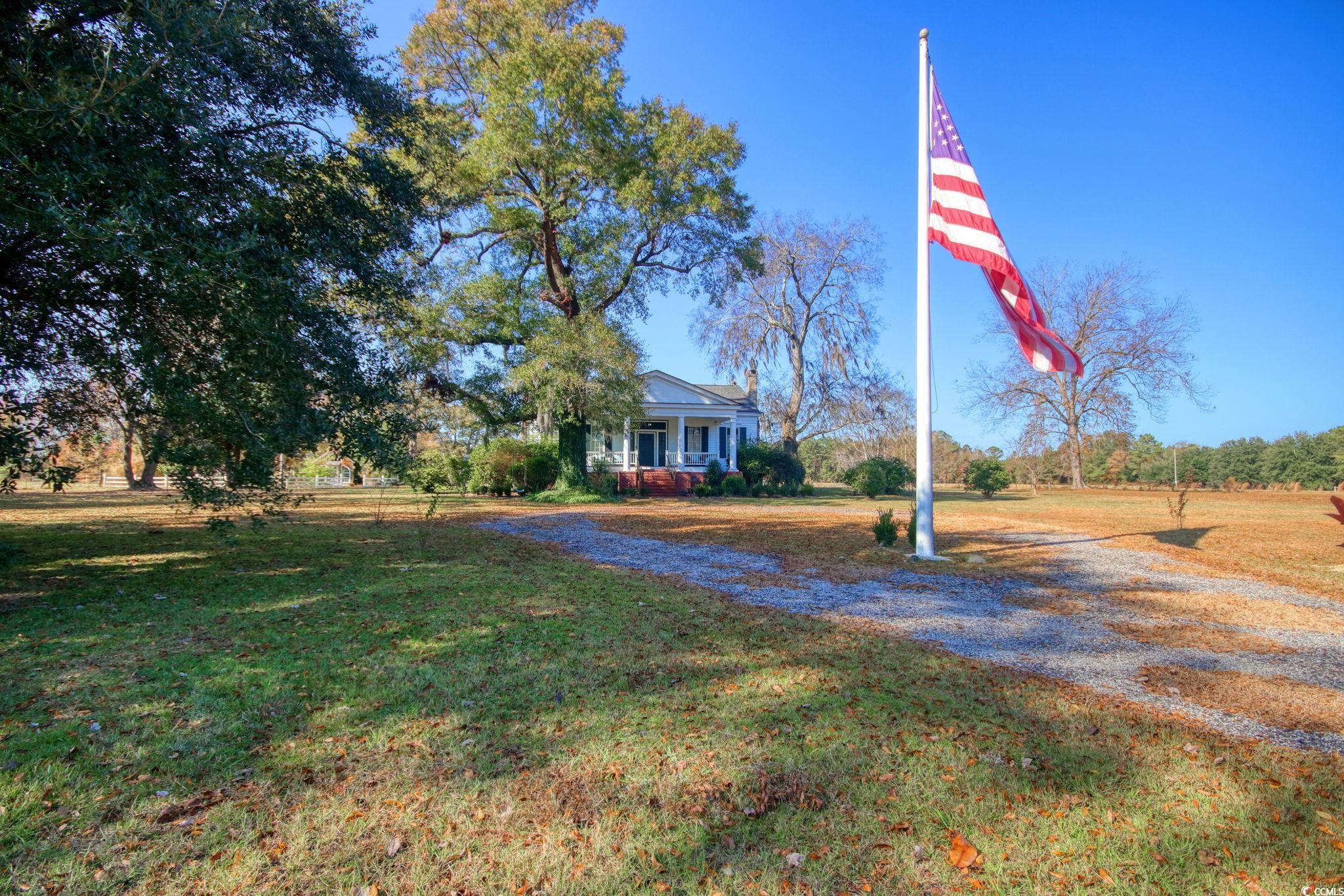 10463 County Line Road Hemingway, SC 29554 - Photo 40 of 40 View of front of house with covered porch and a front lawn