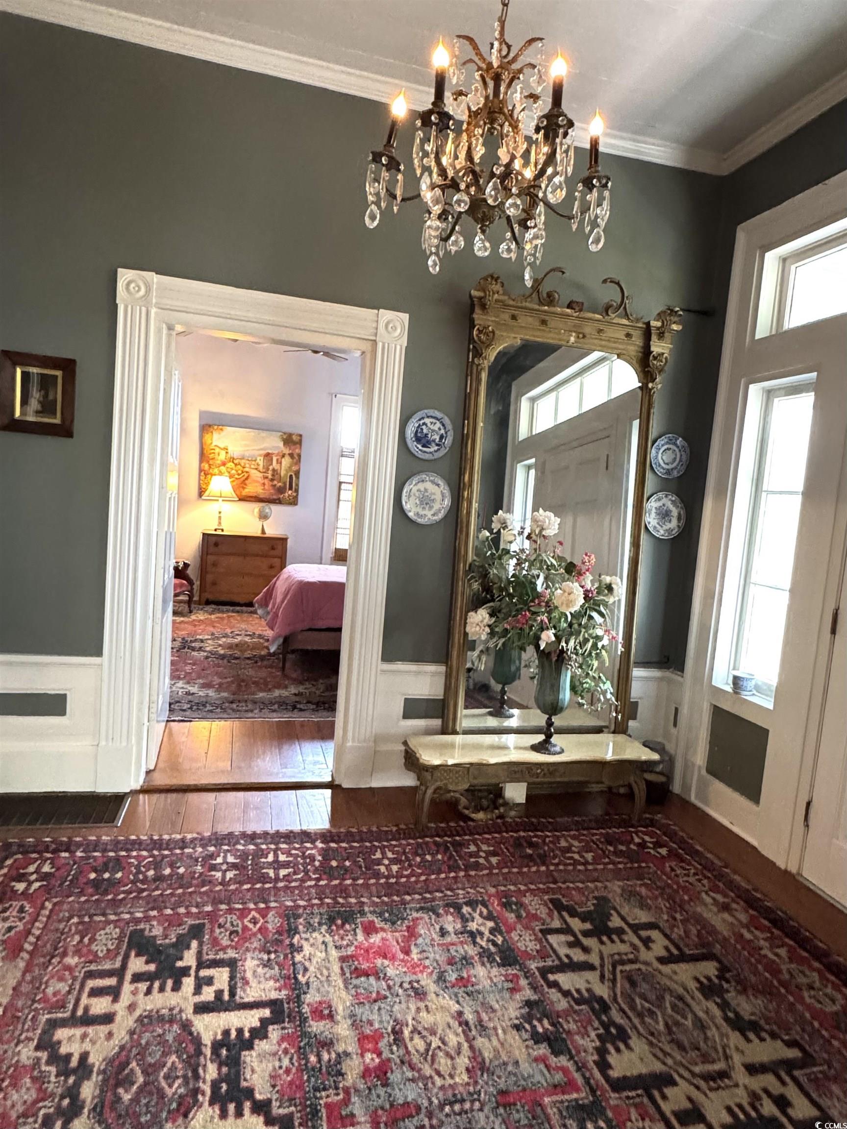 10463 County Line Road Hemingway, SC 29554 - Photo 5 of 40 Entryway with crown molding, hardwood / wood-style floors, and a chandelier